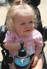 A smiling child in a motorized wheelchair