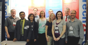 Tech4POD team members in front of a display at the GCMAS meeting